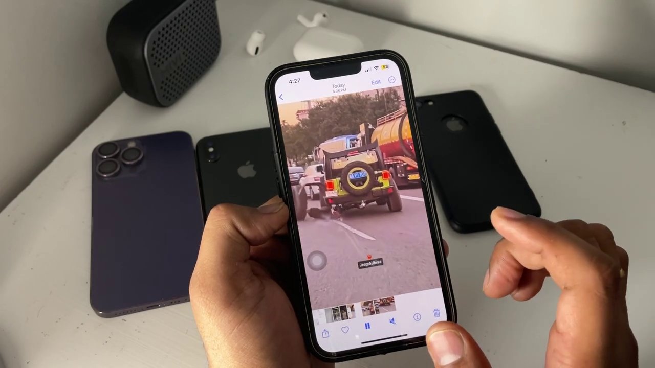 The iPhone's Photos app is open, showing the recently downloaded Instagram Reel in the Recents album.